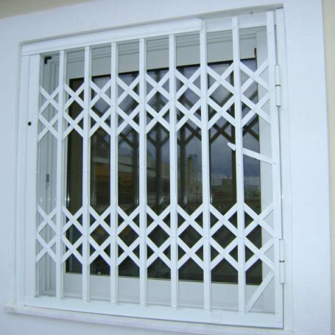 Retractable security gates in a window in a private house